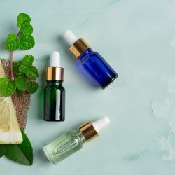 grapefruit oil serum bottle put on green light background